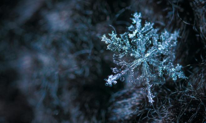 A large snowflake against a dark background