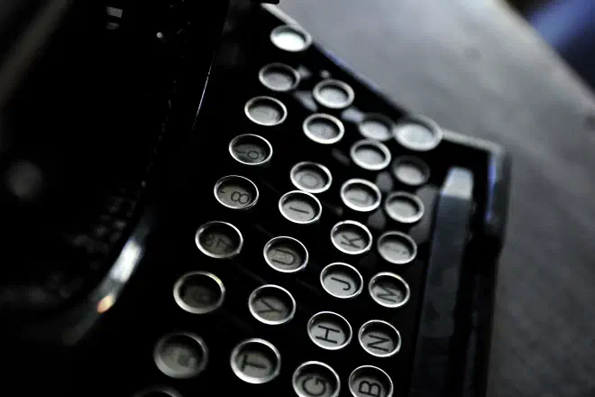 A low colour image of a vintage typewriter.
